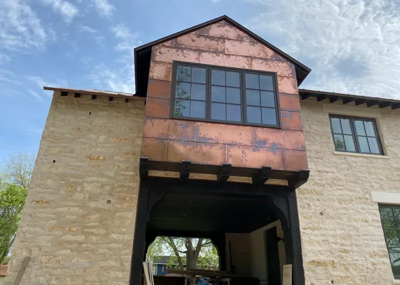 Copper metal panel facade on a stone building for Roof Repair in Presque Isle