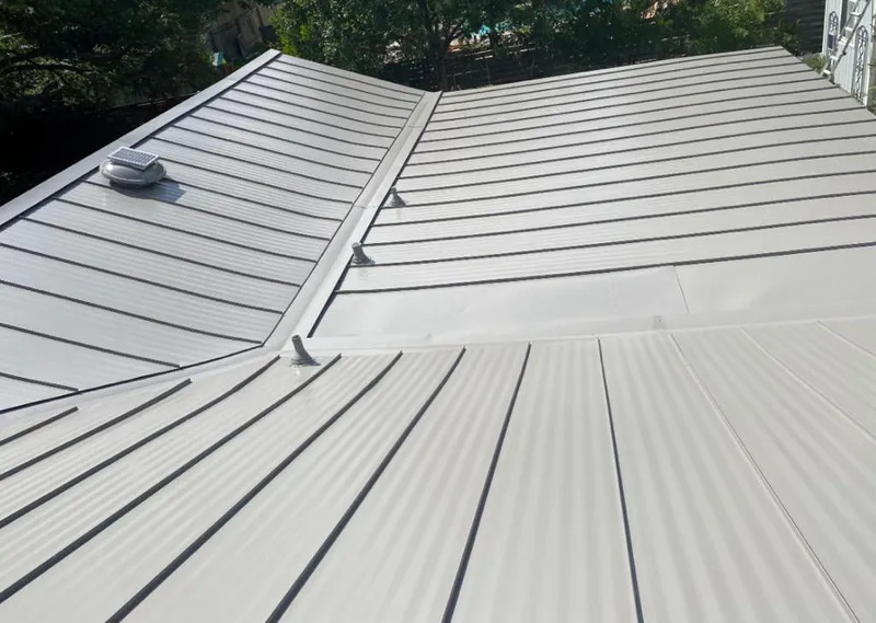 Solar attic fan installed on a metal roof for Roof Ventilation in Presque Isle